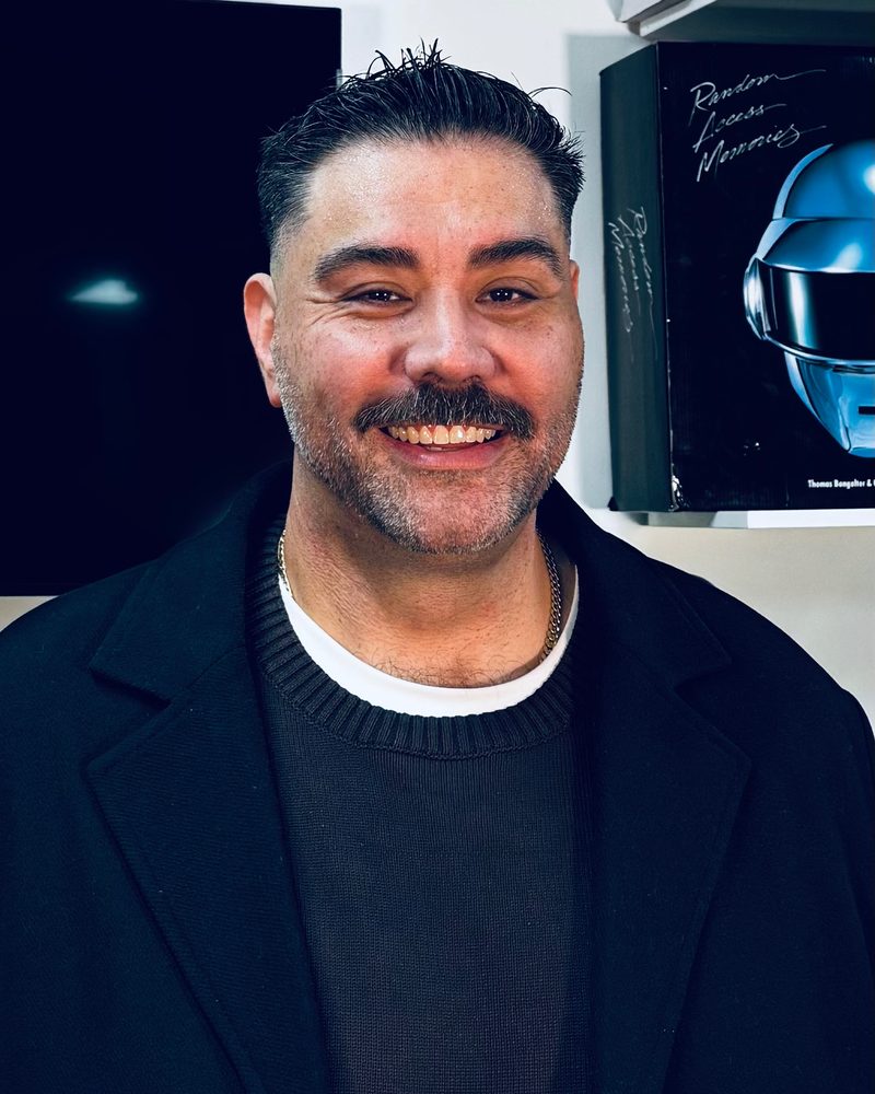 Jonathan Marin smiling in his office